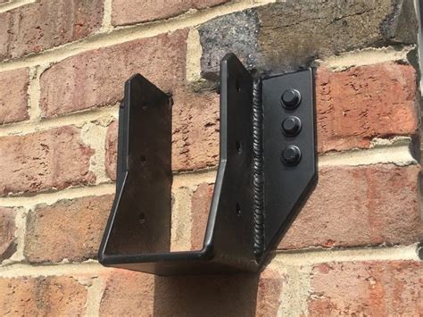 metal bracket behind brick wall|metal inside wall.